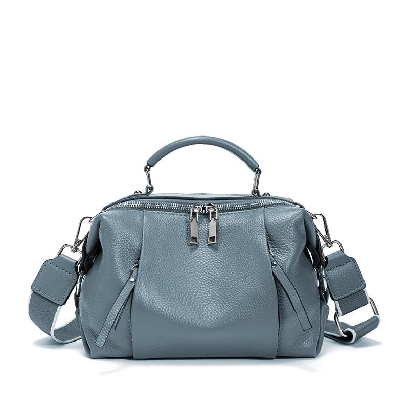 Gray handbag with multiple compartments and straps on a white background