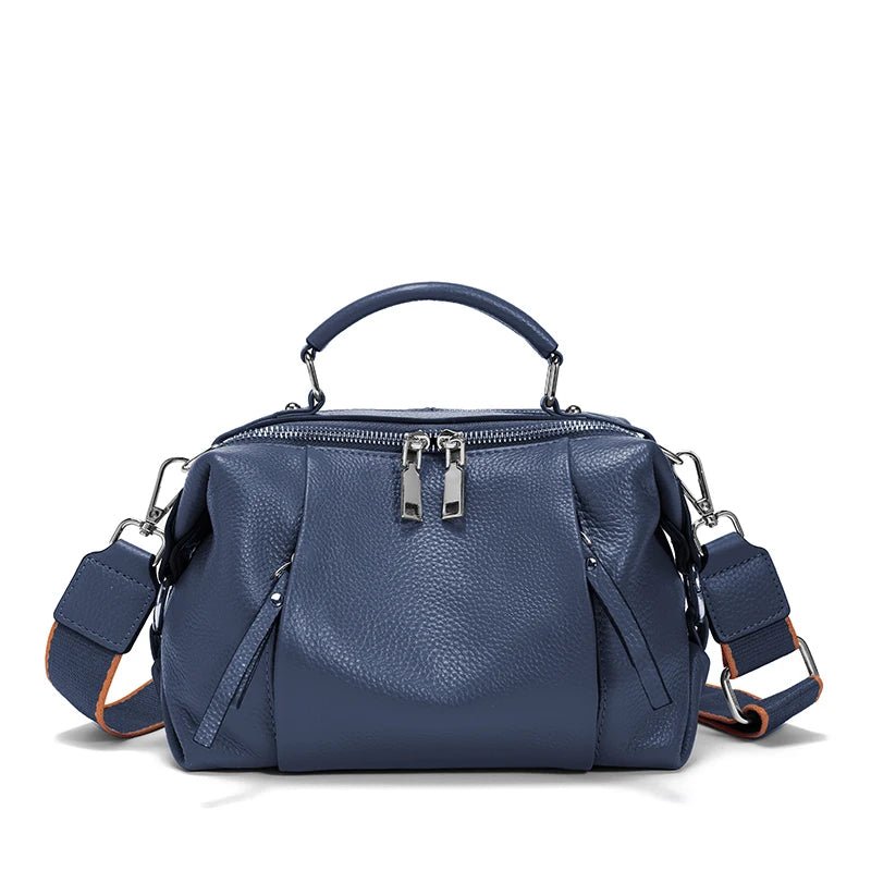 Blue handbag with multiple compartments on a white background
