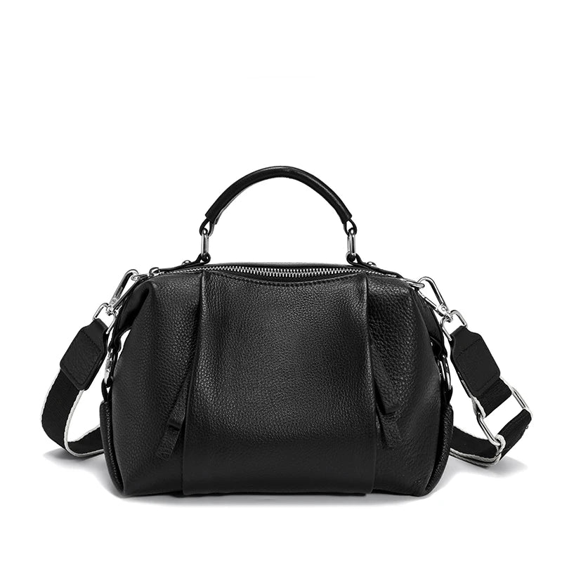 Black leather handbag with a shoulder strap on a white background