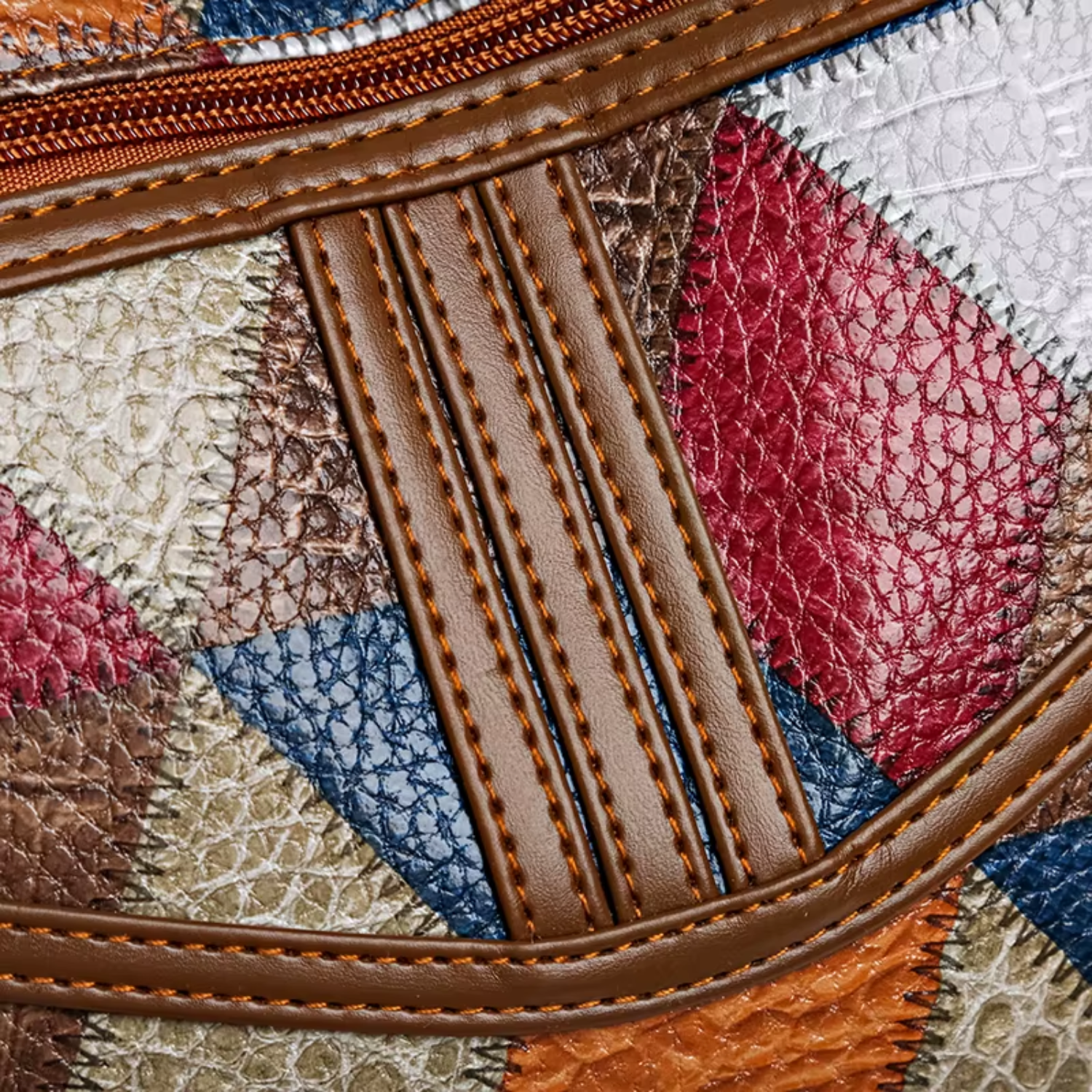 Close-up of geometric patchwork design on vintage PU leather handbag, showing textured details.