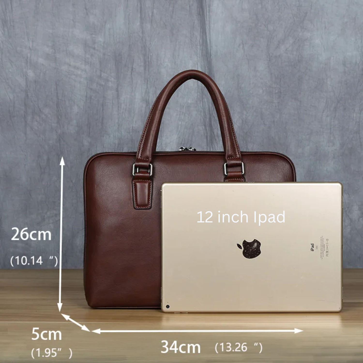Brown leather briefcase next to a 12-inch iPad with dimensions indicated on a gray background