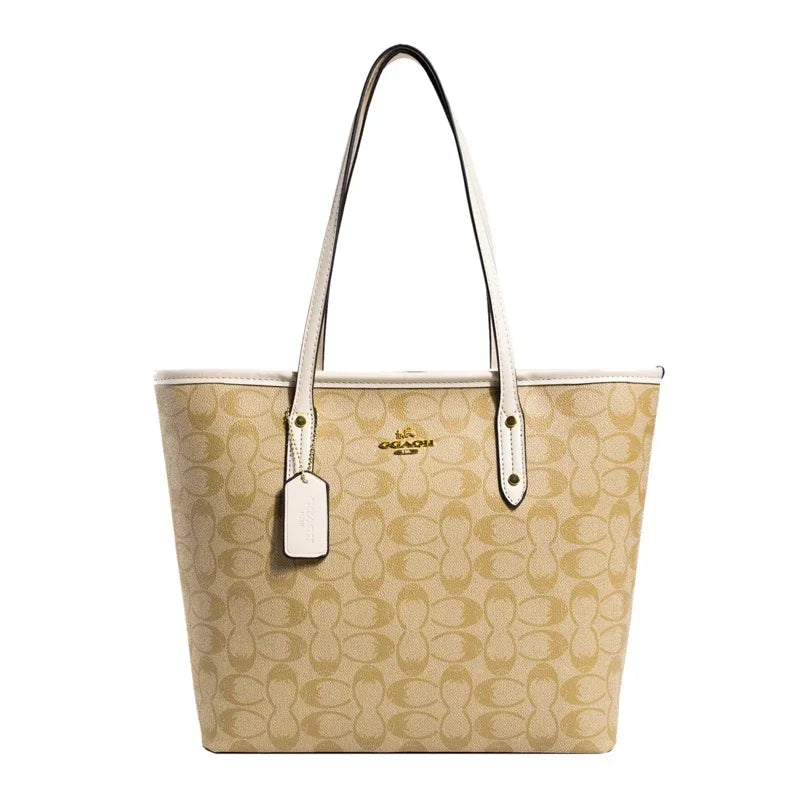 Beige handbag with a visible brand tag on a white background