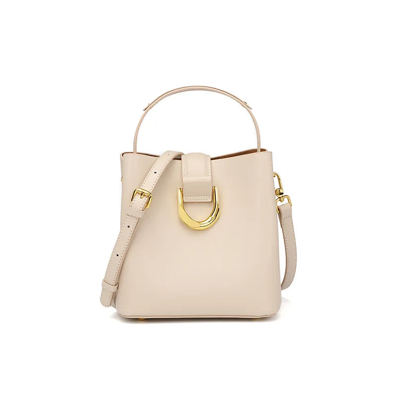 Beige handbag with gold accents on a white background