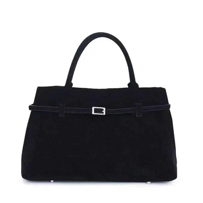 Black handbag with a strap on a white background