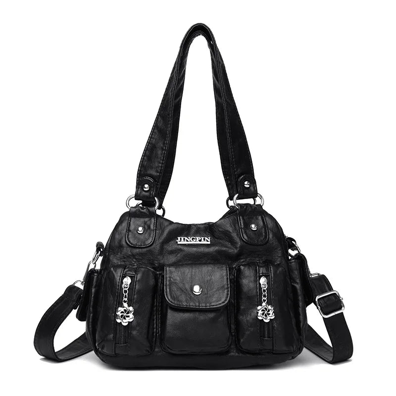 Black handbag with multiple pockets and straps on a white background