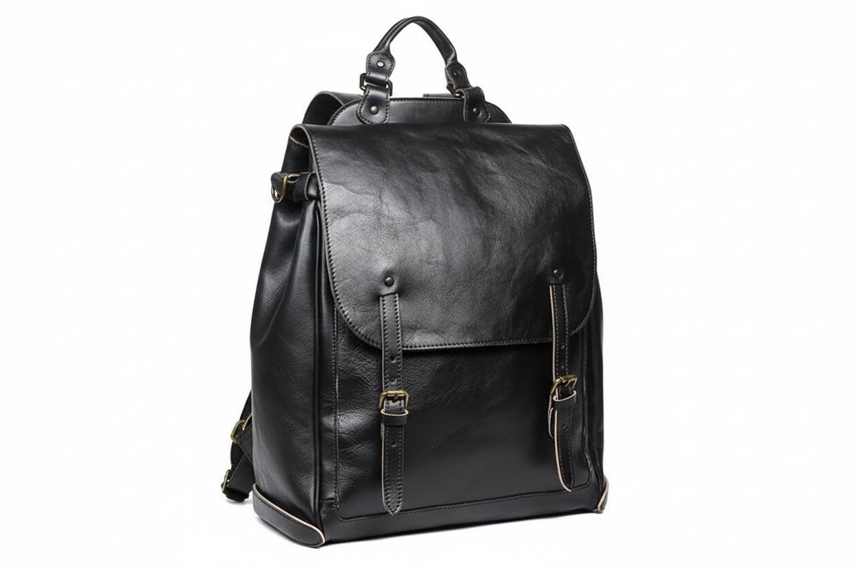Black leather backpack on a wooden surface with a gray background