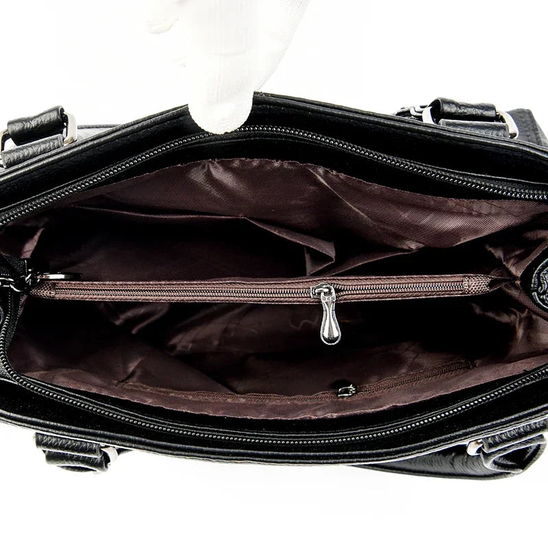 Black leather bag with open interior showing a white sock inside on a white background