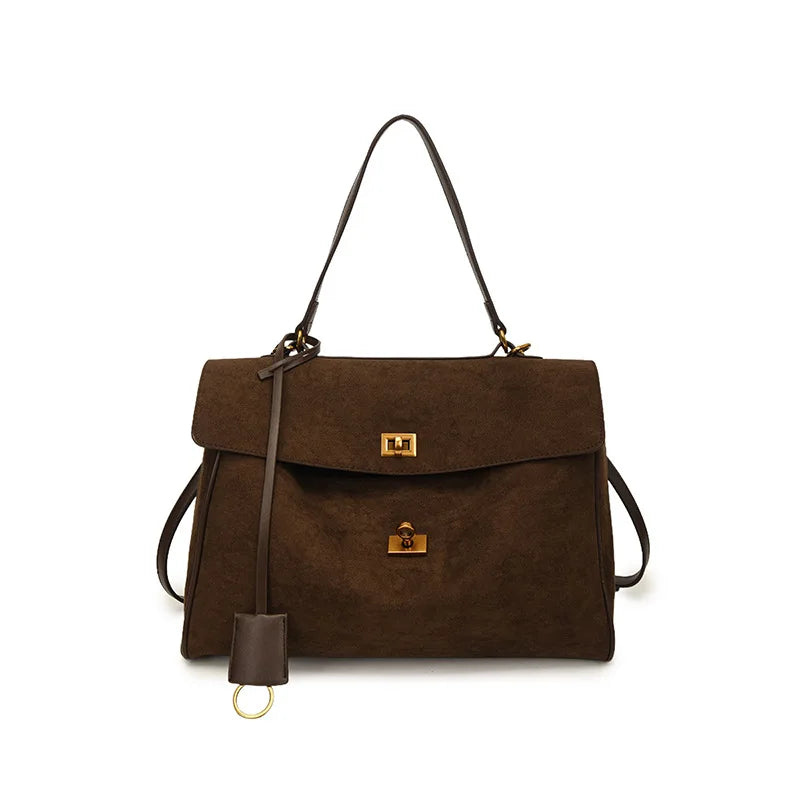 Brown handbag with a gold clasp on a white background