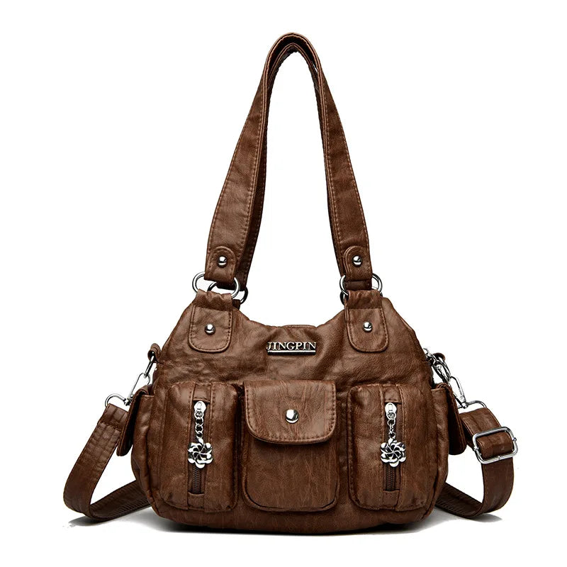 Brown handbag with multiple pockets and straps on a white background