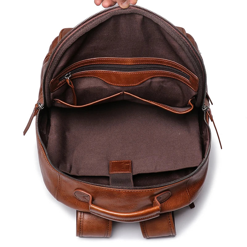 Brown leather backpack with open front compartment on a white background