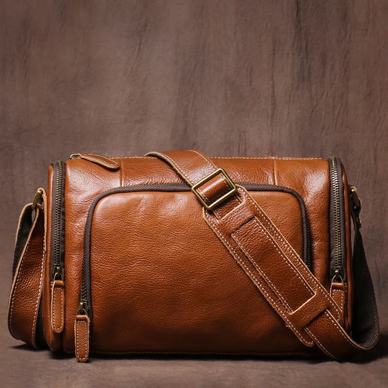 Brown leather bag with a strap on a brown background