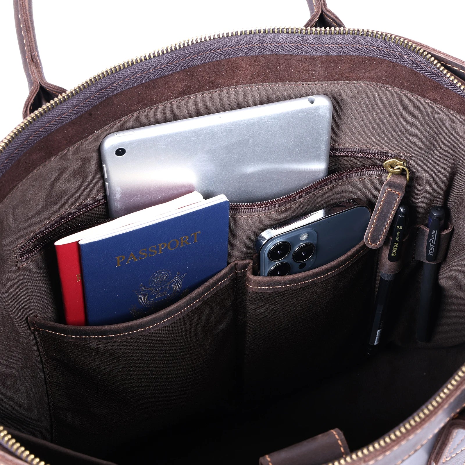 Brown leather bag with compartments holding a passport, phone, and other items.