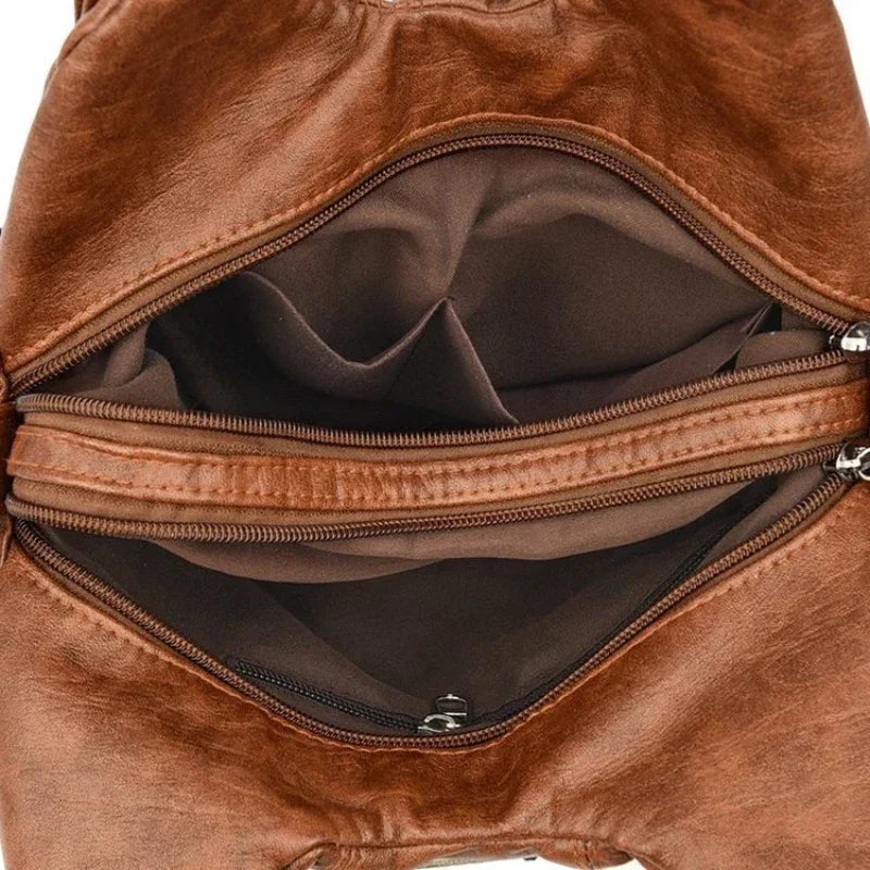 Brown leather bag with open zipper showing interior