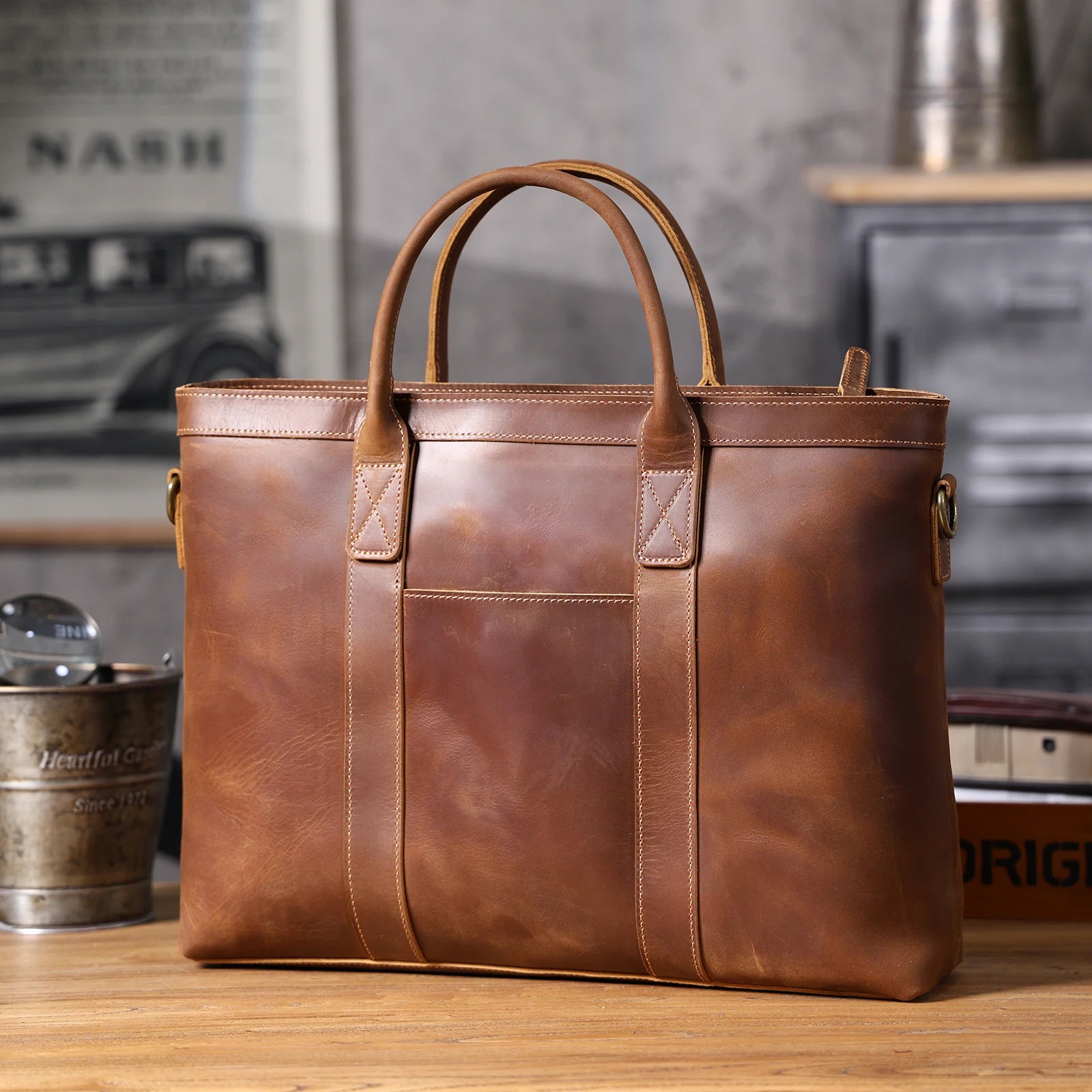 Brown leather briefcase on a wooden surface with a blurred background