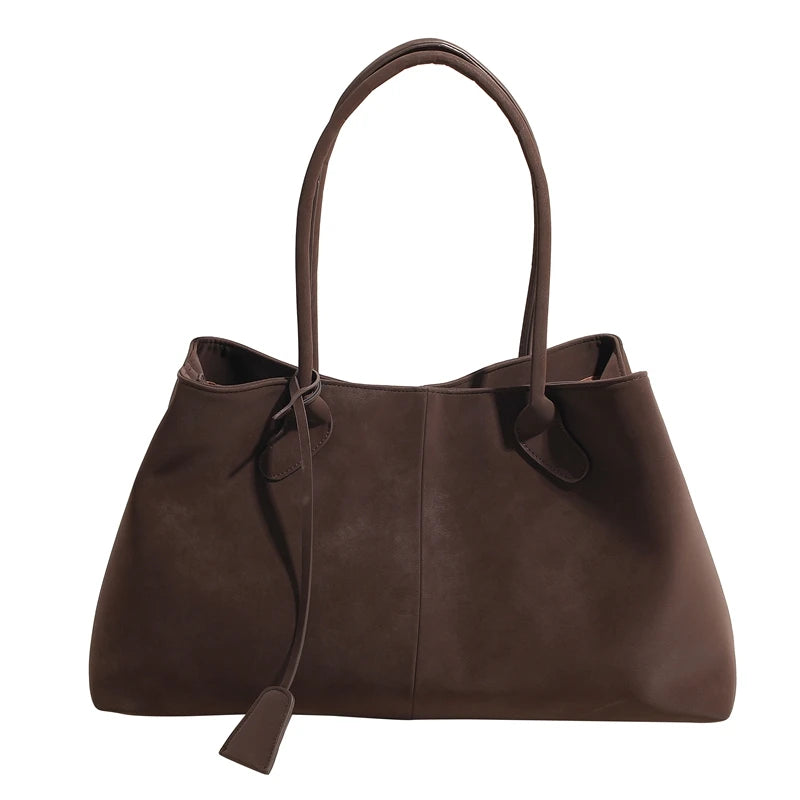 Brown leather handbag with a strap on a white background
