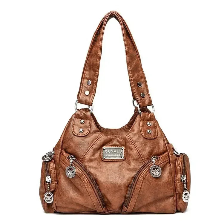 Brown leather handbag with silver accents on a white background