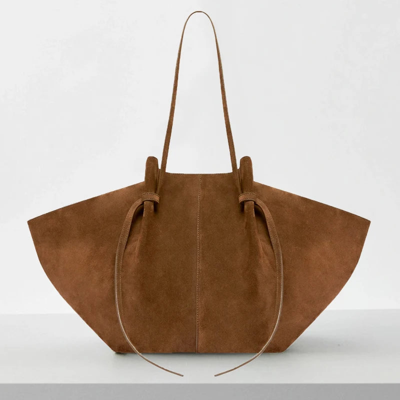 Brown suede handbag on a white background