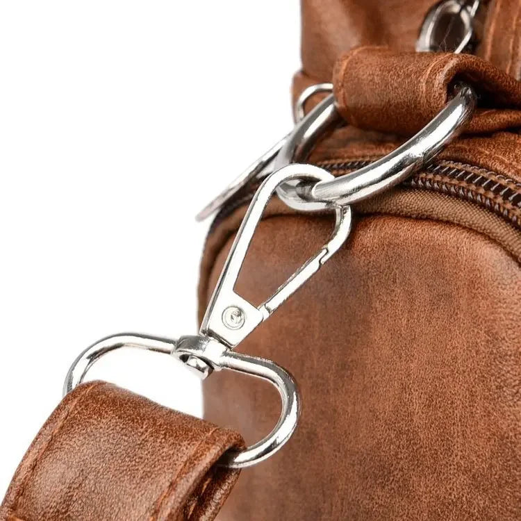 Close-up of a brown leather bag with a silver clasp on a white background
