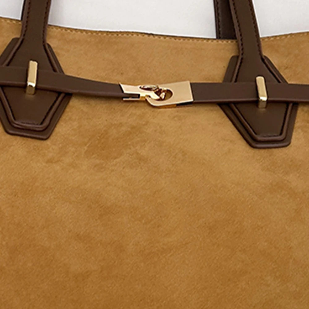 Close-up of a brown leather bag with gold hardware