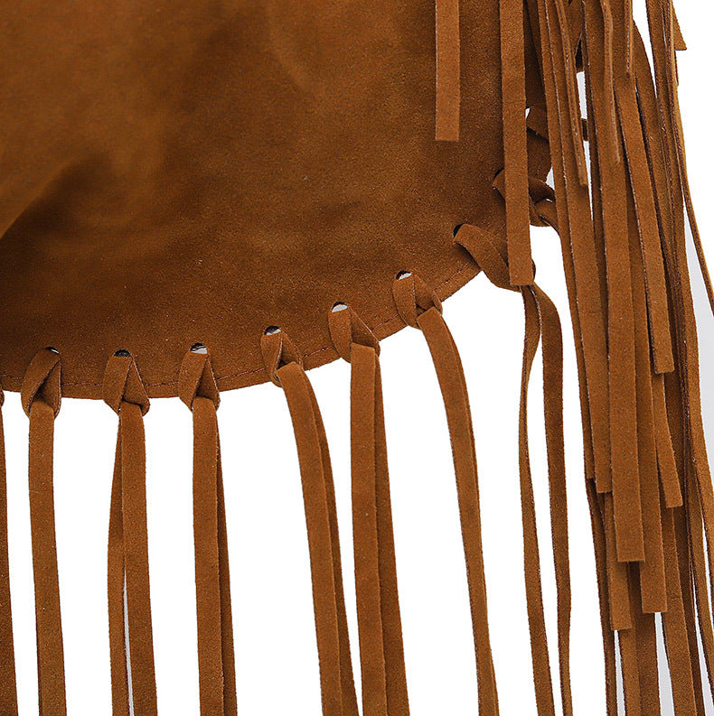 Close-up of brown leather fringe on a white background