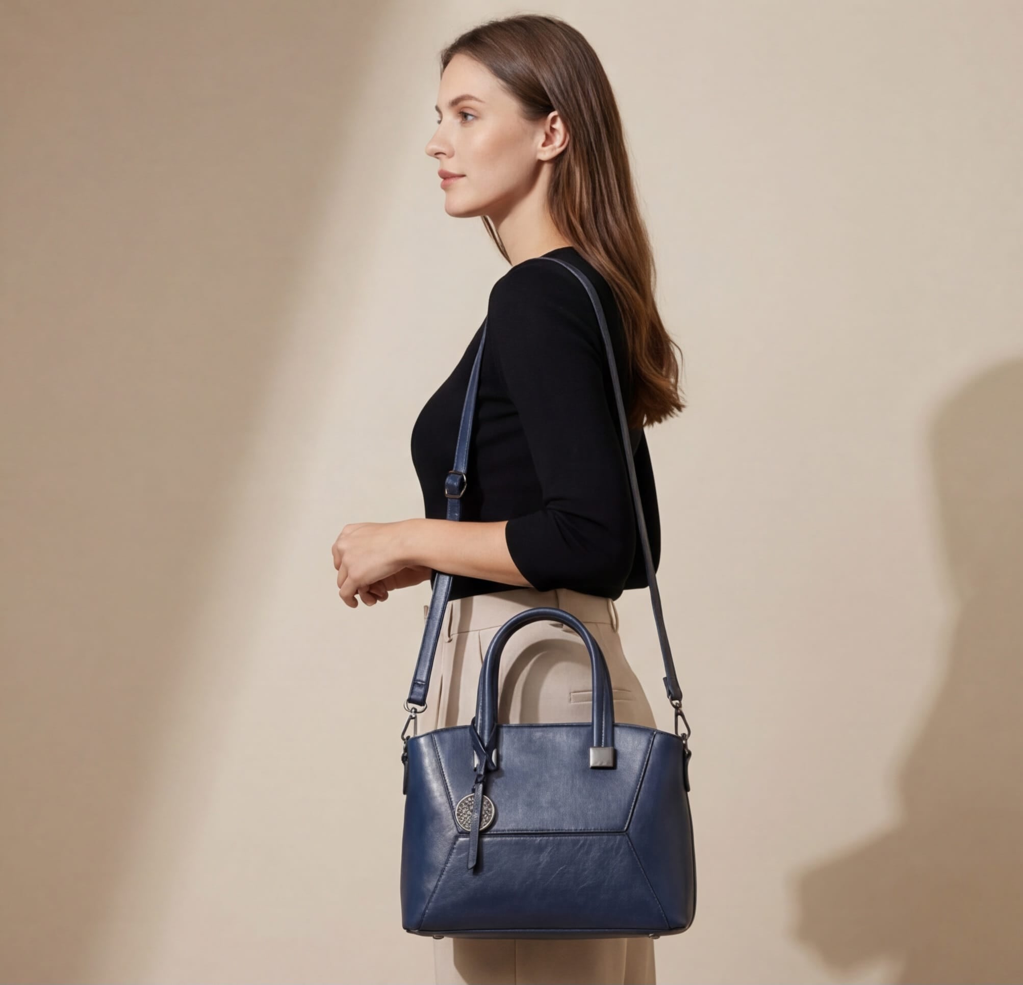 Woman carrying a blue handbag against a beige background