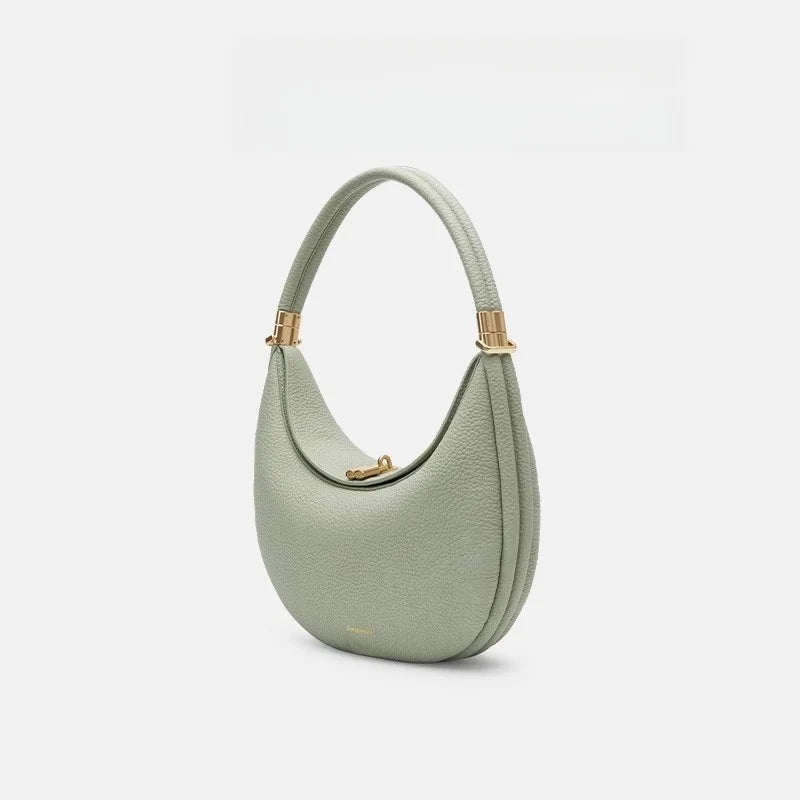 Light green handbag with gold accents on a white background