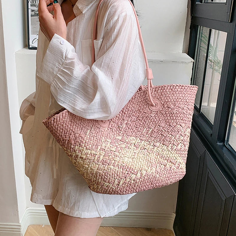 Person holding a pink woven bag indoors