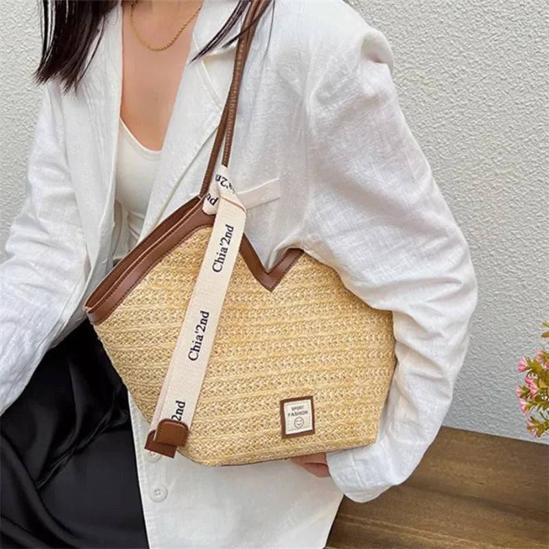 Person holding a straw handbag with a visible brand tag against a neutral background