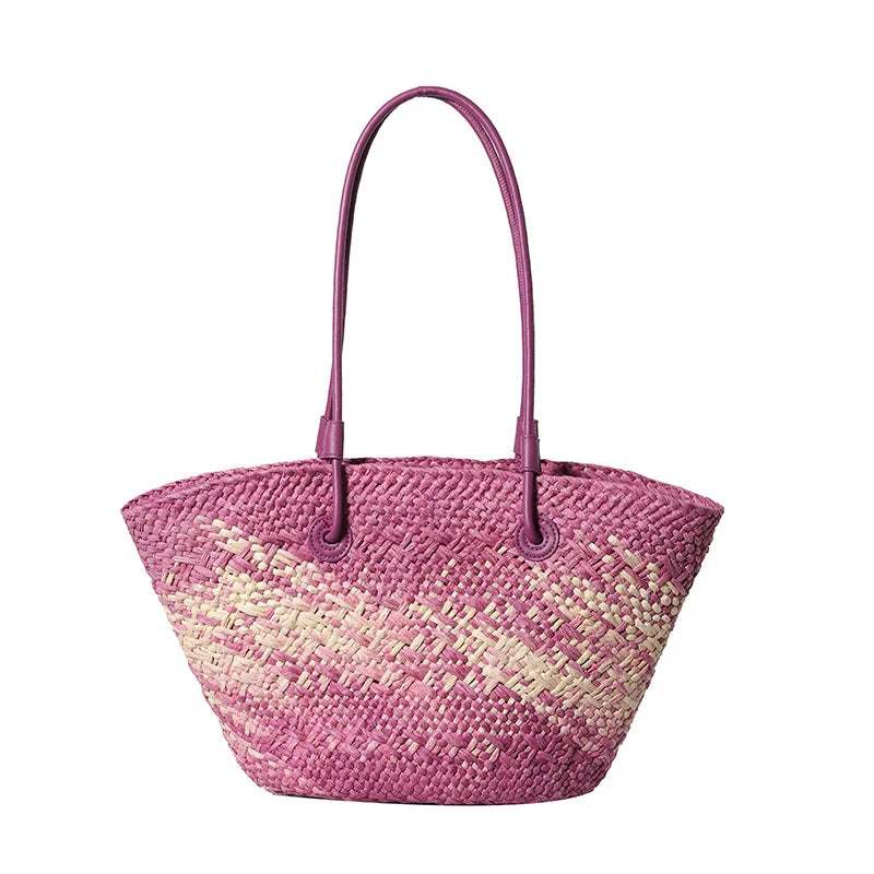 Pink woven handbag with a handle on a white background