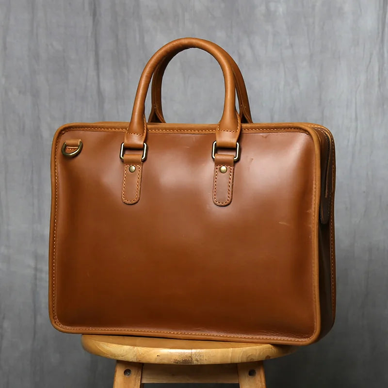 Brown leather briefcase on a wooden stand against a gray background