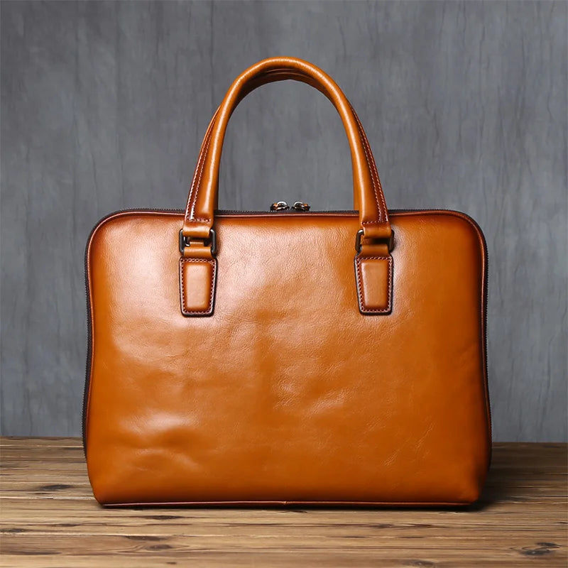 Brown leather briefcase on a wooden surface with a gray textured background