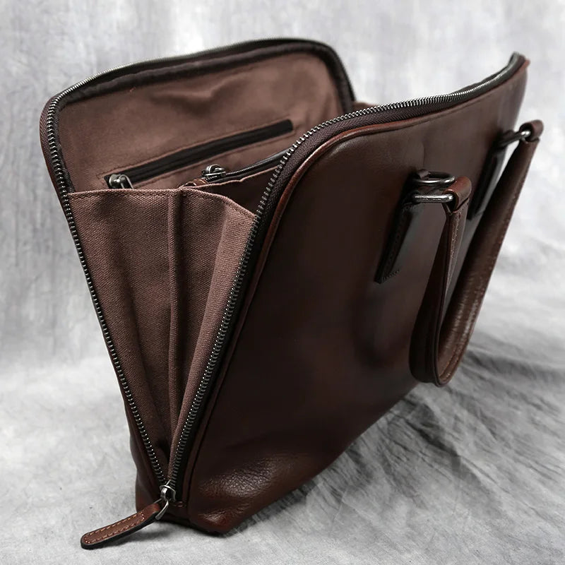 Brown leather bag with a zipper on a gray textured background