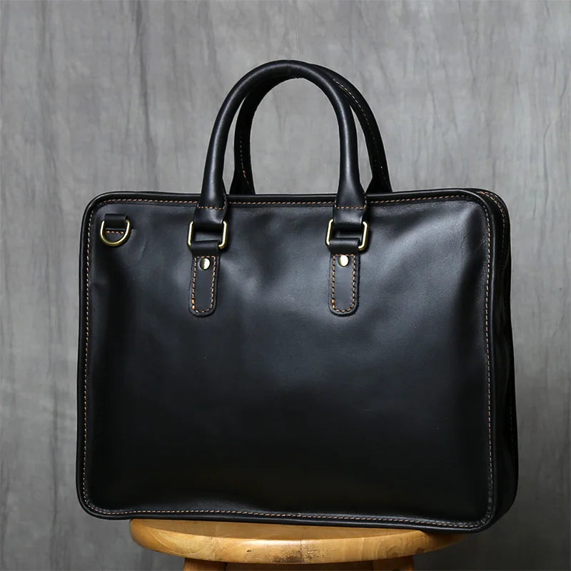 Black leather briefcase on a wooden stool with a gray background
