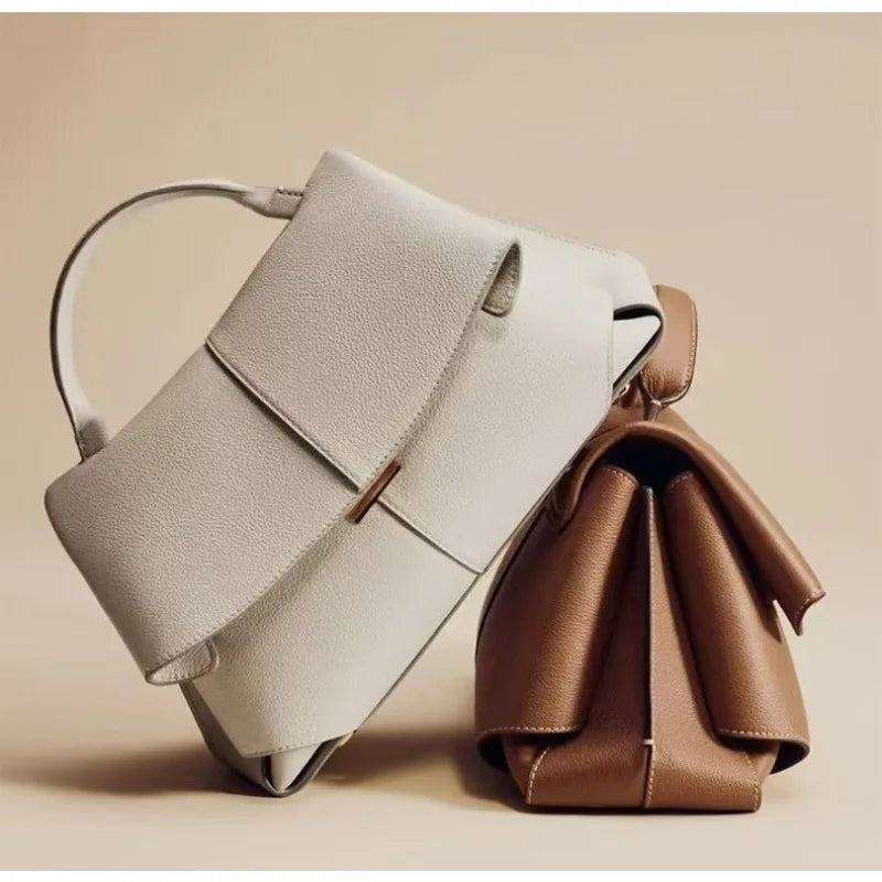 Two handbags, one beige and one brown, on a beige background
