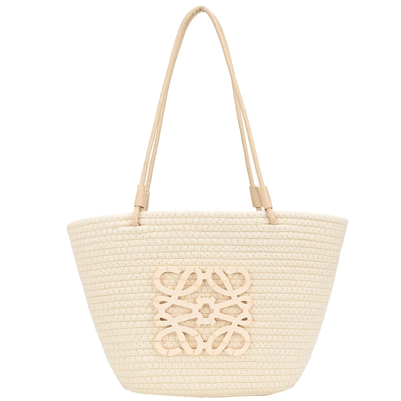 White woven tote bag with decorative cutout on a white background