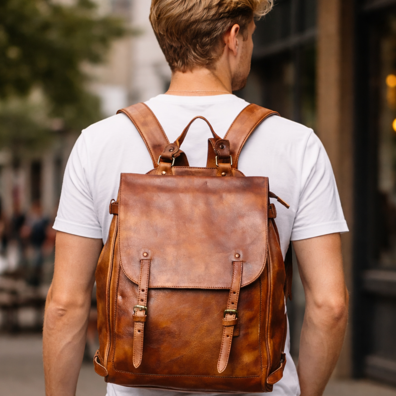 blonde man walking on the street with the brown leather backpack