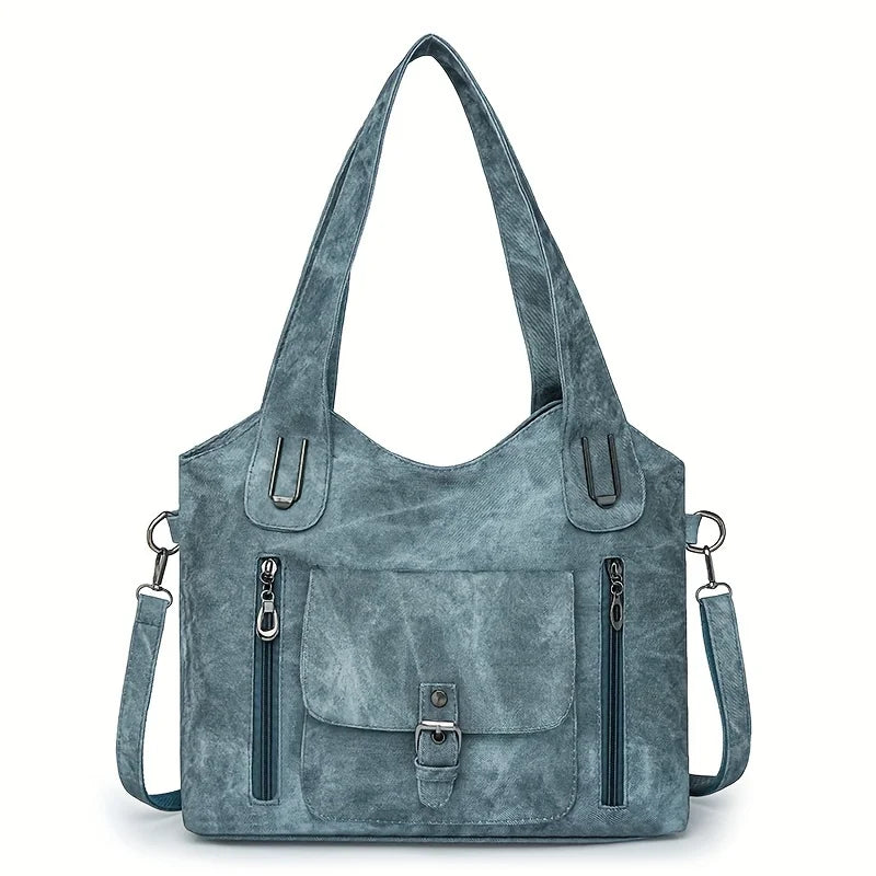 blue retro soft leather tote bag with front pockets and shoulder strap on white background