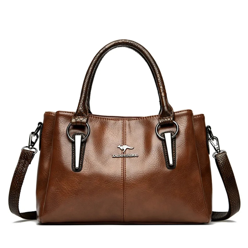 Elegant brown leather handbag with brown crocodile-patterned handles and detachable shoulder strap.