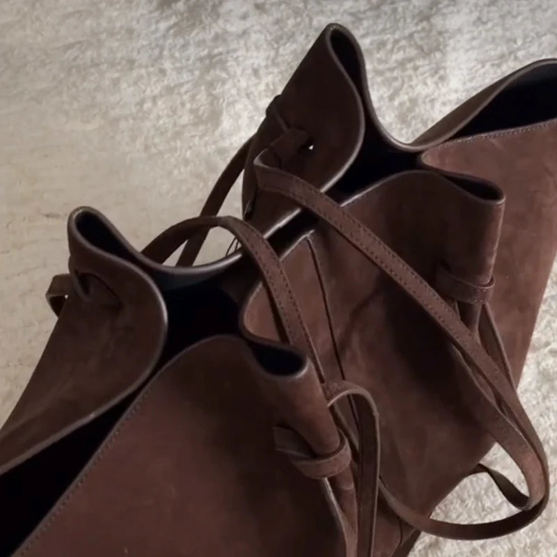 top view of brown suede tote bag showing handles and open interior