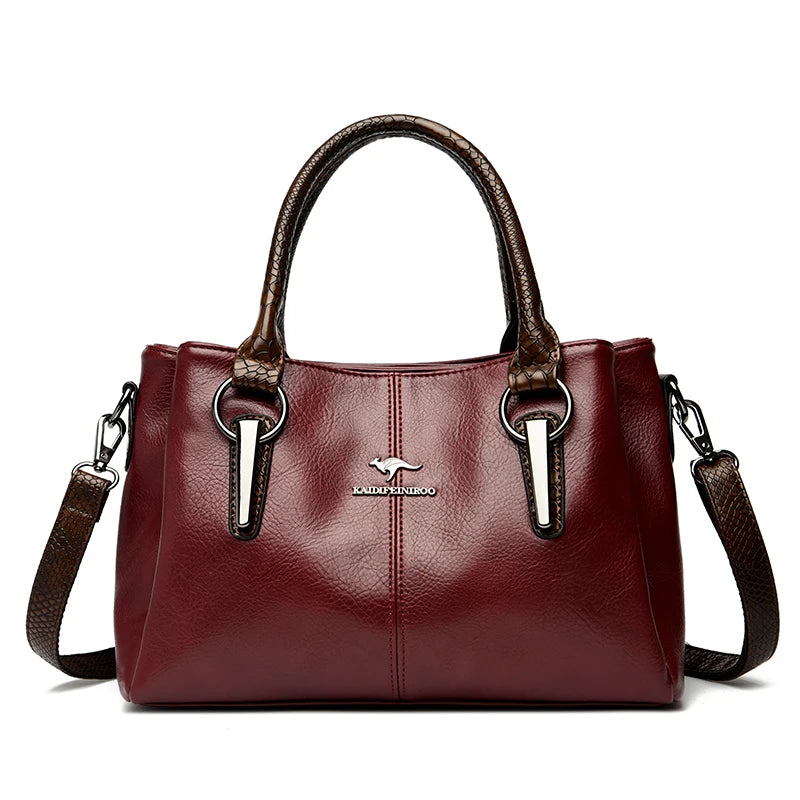 Elegant burgundy leather handbag with brown crocodile-patterned handles and detachable shoulder strap.