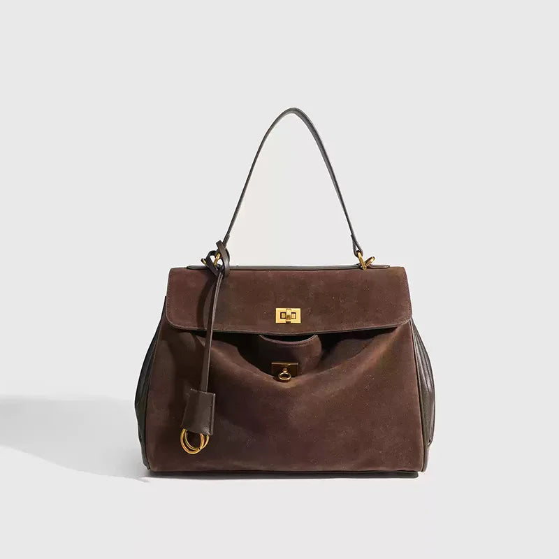 Dark Brown handbag with gold accents on a light gray background