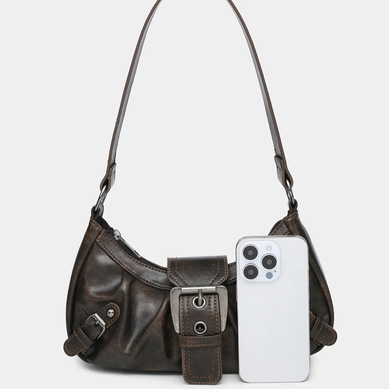 Dark brown leather shoulder bag with a smartphone placed in front for size reference