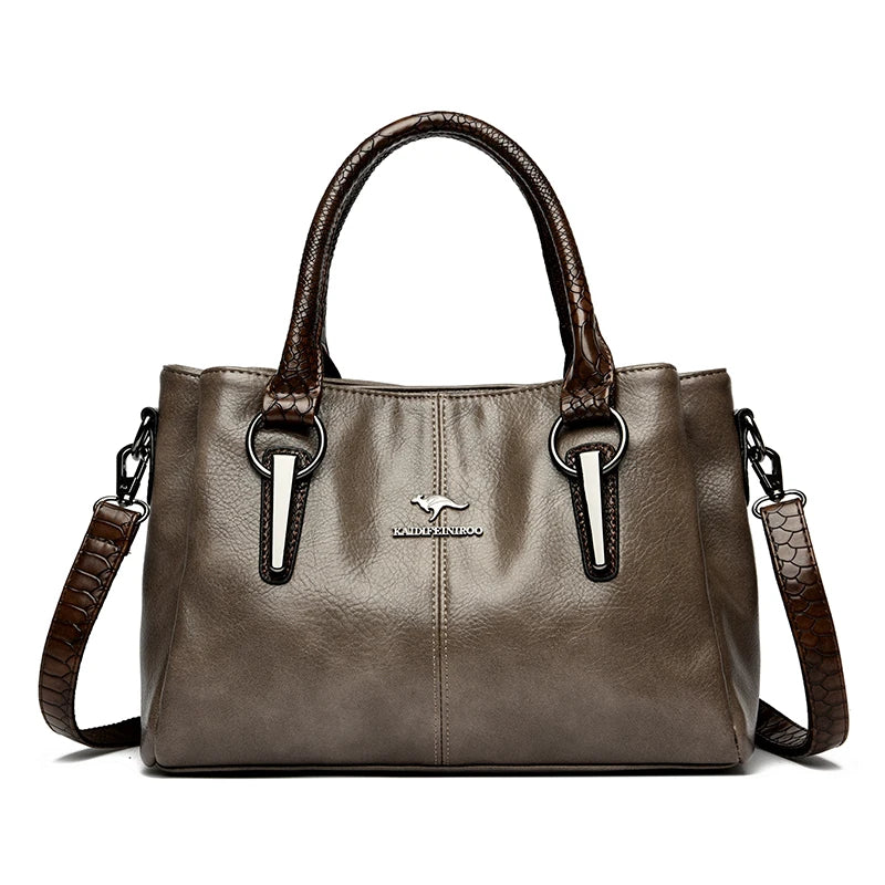 Elegant taupe leather handbag with brown crocodile-patterned handles and detachable shoulder strap.