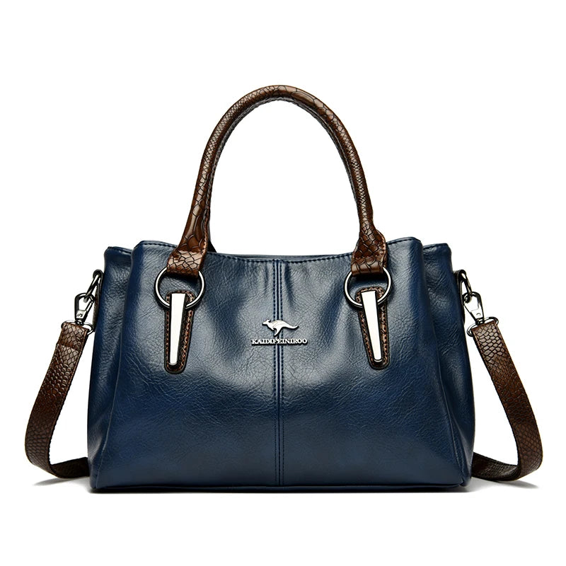 Elegant navy blue leather handbag with brown crocodile-patterned handles and detachable shoulder strap.