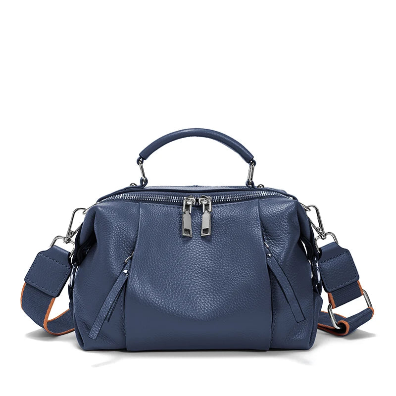 Blue handbag with multiple compartments on a white background