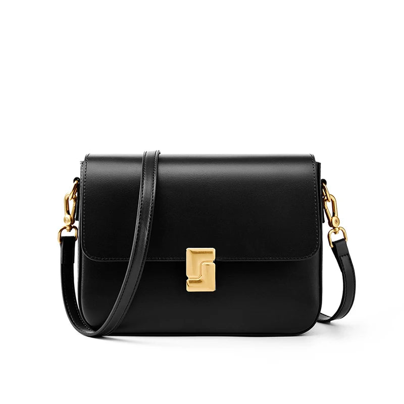 Black handbag with gold clasp on a white background